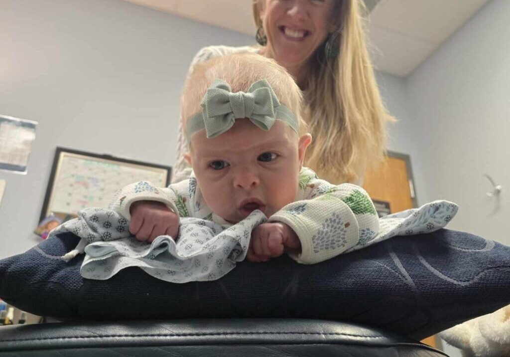 Dr. Brenda giving a baby a gentle chiropractic adjustment